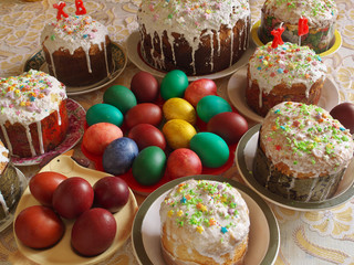 Traditional homemade iced Easter cakes kulich, with painted colored eggs, selective focus