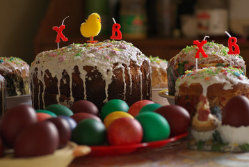 Traditional homemade iced Easter cakes kulich, with painted colored eggs, selective focus