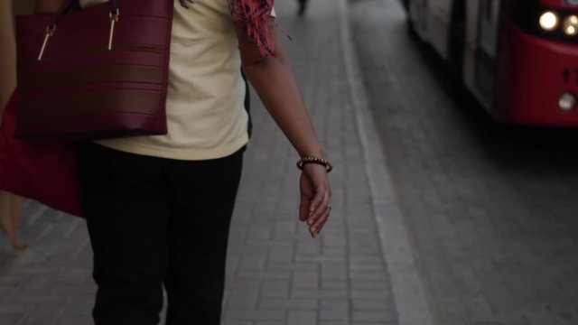 A middle eastern woman walks down the street of Dubai in the UAE.