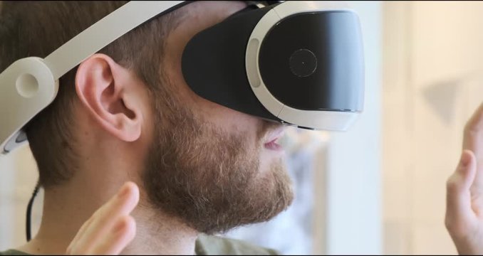Man using virtual reality headset indoors 4k, close-up