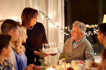celebration and family concept - happy family having birthday party at home