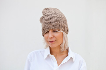 Pretty young woman in warm brown beanie
