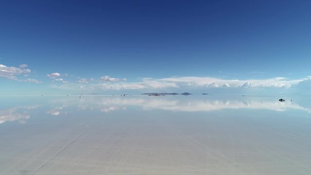 Aerial view of world&rsquo;s largest salt flat Salar de Uyuni, sky reflection on water surface - landscape panorama of Bolivia from above, South America