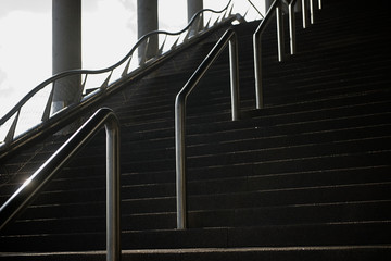 Concrete staircase with metal handrails