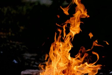 Burning woods on the ground floor with a flame and fire sparking in outdoor place with dark background 
