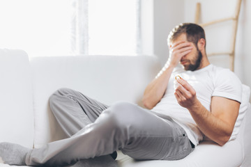 Heartbroken man holding a wedding ring