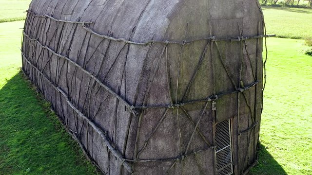 Aerial medium close of side and front of replica Native American Longhouse, Herr House property, Lancaster County, PA Concept: educational, replica, Native American culture, interactive exhibit