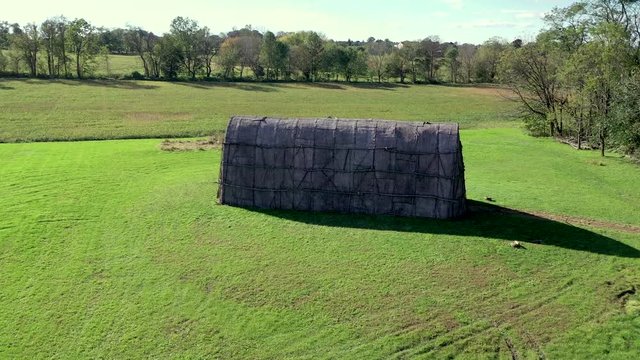 Aerial slow approach to Native American Longhouse on the Herr House property, Lancaster County PA.Concept: educational, replica, Native American culture, interactive exhibit