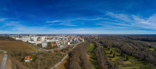 Lonely villa in front of the metropole Munich as aerial drone shot under a blue sky