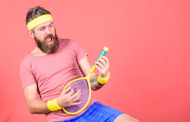 Having fun. Tennis active leisure. Athlete hipster hold tennis racket in hand red background....