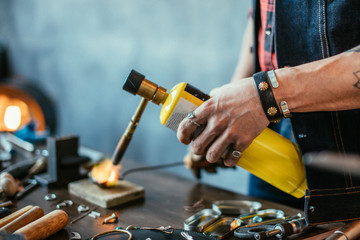 jewelery creation, close up side view photo, man making material for jewellery