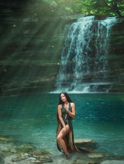 Fototapeta na wymiar Magic tropical nature, dark-haired sexy girl comes out of the azure transparent clear waterfall lake water, sea nymph in green dress with deep neckline. Mermaid in the sun rays. Art photography