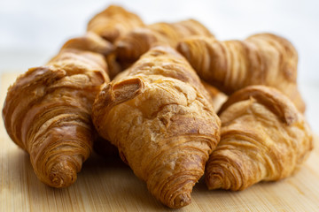 Fresh baked croissants on white background