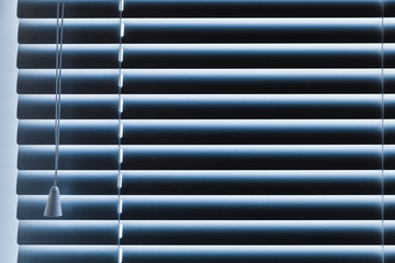Obraz premium Closed horizontal blue window blinds