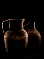 vintage clay jugs on black