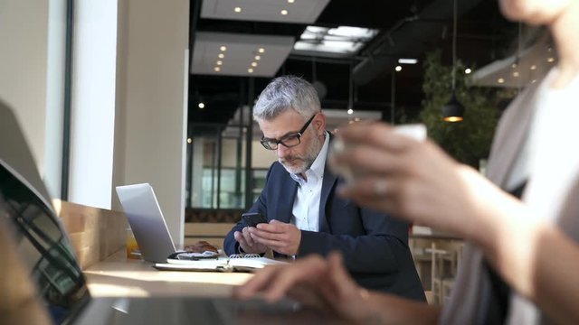 Businessman working during layover at modern airport