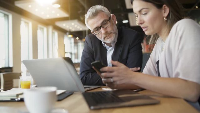 Salesman and manager discussing ideas in modern office space