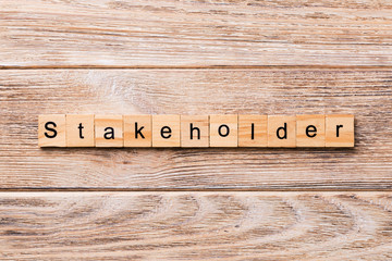 Stakeholder word written on wood block. Stakeholder text on wooden table for your desing, concept