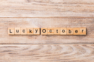 lucky october word written on wood block. lucky october text on table, concept