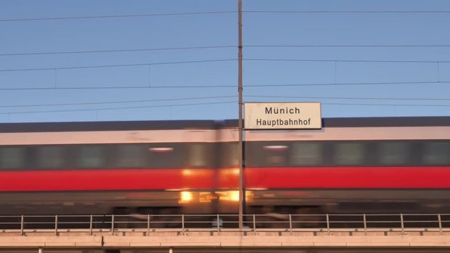 munich railway billboard train passing behind train station signboard