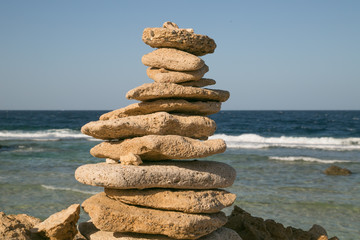 Fototapeta na wymiar Coloured rock cairns by the Red sea