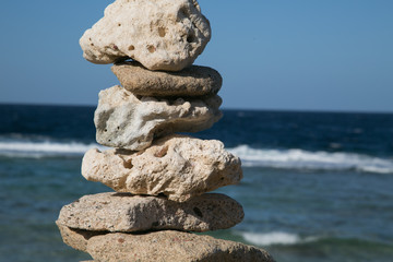 Coloured rock cairns by the Red sea