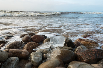Fototapeta na wymiar Ice on the coast of sea.