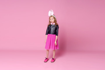 Funny baby girl in the form of Easter Bunny. Concept of holidays, beauty and fashion. Selective focus.