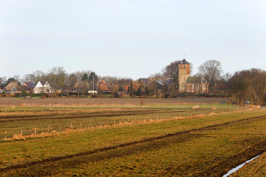 Old traditional church and fields in Hippolytushoef at spring, Hollands Kroon, Netherlands.