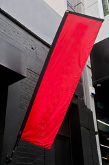 Red big wide signboard placed on a street by a real estate compa © eyeofpaul