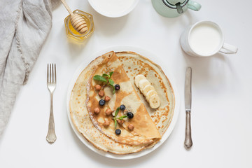 Tasty traditional russian pancakes, sour cream, honey. Springtime. Shrovetide.