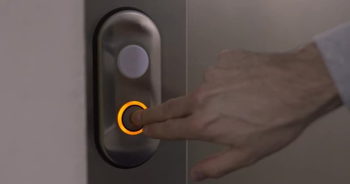 Man presses a button for the elevator. 4k