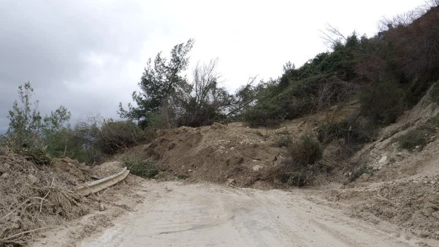 View of a mountain road devastated by a landslide on the path between Agios Nikolaos village and Mandria Village in Europe