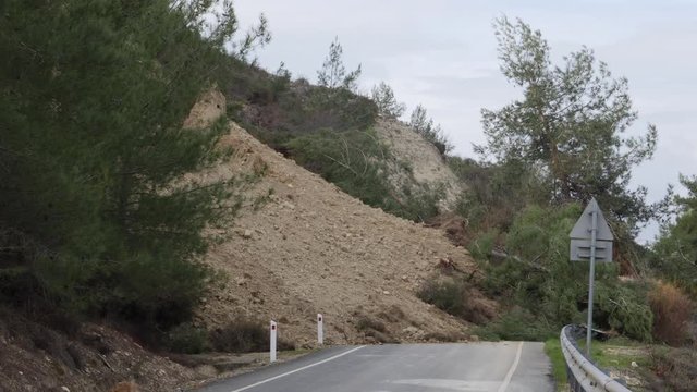 View of a mountainside road covered in dirt after a landslide between Agios Nikolaos village and Mandria Village in Europe