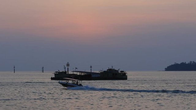 Footage of Fisherman boat Pass-by at Waterfront Kota Kinabalu, Sabah, Borneo during Beautiful sunseet .Kota Kinabalu waterfront is famous tourist spot during sunset.