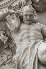 Fototapeta na wymiar Statue of powerful and emotional atlas of Renaissance Era in Vienna, Austria, details, closeup