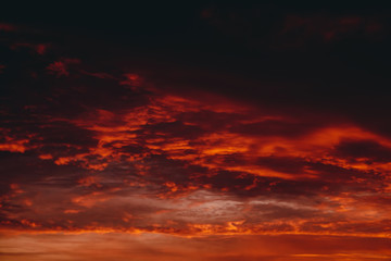 Fiery red blood vampire dawn. Amazing warm dramatic fire cloudy sky. Vivid orange sunlight....