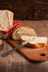 Bakery - gold rustic crusty loaves of bread and buns on black chalkboard background. Still life captured from above