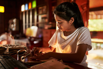 thai teen girl doing homework and studying at home