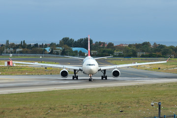 Fototapeta na wymiar Airplane taxiing on runway of the airport