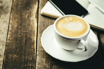 BUsiness morning concept - coffee, notebook, phone, rustic wood background
