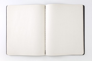 Graph paper sheet. Closeup of open notebook, on white background.