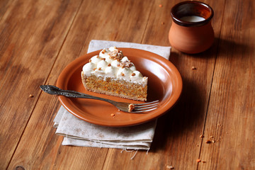 Carrot Tart with Apple Filling and Cream Cheese Frosting, on wooden table.