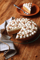 Carrot Tart with Apple Filling and Cream Cheese Frosting, on wooden table.