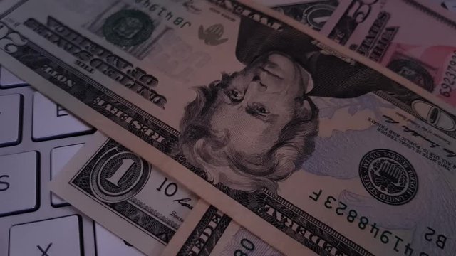 US dollar falling onto a keyboard