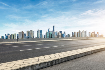 Empty asphalt road and panoramic city skyline with buildings in Shanghai