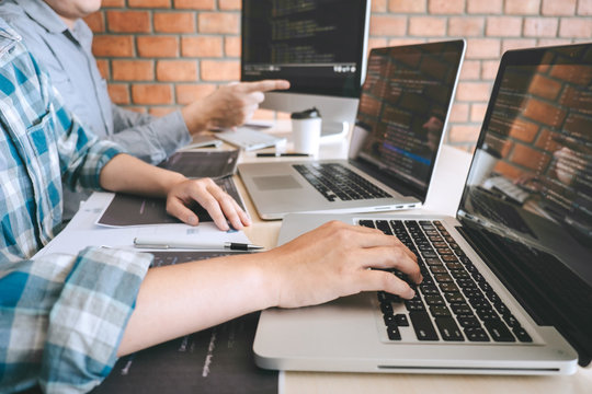 Team of Professional Developer programmer cooperation meeting and brainstorming and programming in website working a software and coding technology, writing codes and database