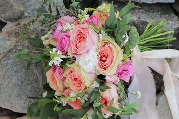 Bridal bouquet lying on the rocks