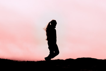 silhouette of girl on top of the mountain