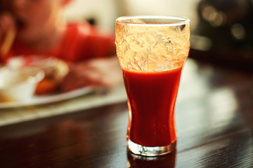 a glass of tomato juice on a table